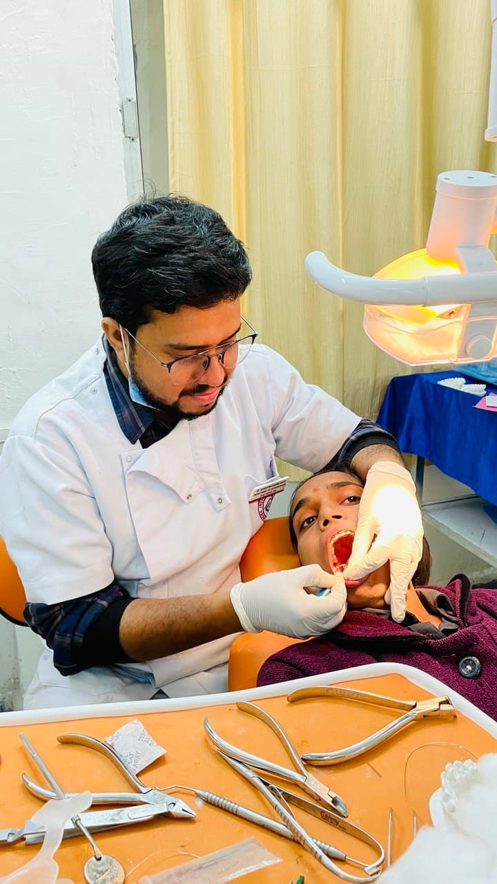 Dr. Sahu performing a chairside clinical procedure